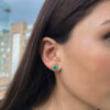 Yellow gold round emerald studs with diamond jackets