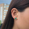 Yellow gold round emerald studs with diamond jackets