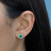 Yellow gold round emerald studs with diamond jackets