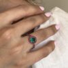 Round Colombian emerald ring with natural ruby halo