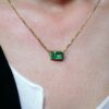 Trilogy of baguette cut emerald pendant