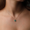 0.81 Emerald pendant with diamond halo